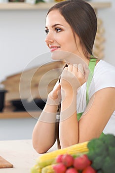 Two women friends cooking in kitchen while having a pleasure talk. Friendship and Chef Cook concept