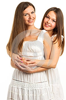 Two women friends laughing with a perfect white teeth with a green background