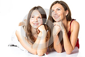 Two women friends laughing with a perfect white teeth with a green background