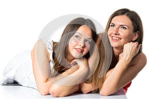 Two women friends laughing with a perfect white teeth with a green background