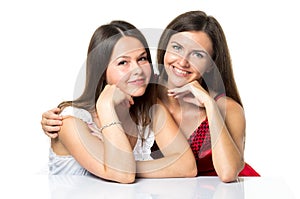 Two women friends laughing with a perfect white teeth with a green background