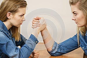 Two women having arm wrestling fight