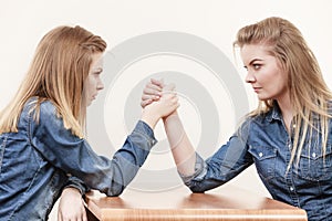 Two women having arm wrestling fight