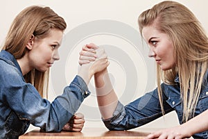 Two women having arm wrestling fight