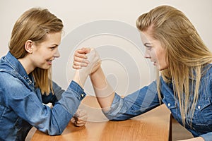 Two women having arm wrestling fight