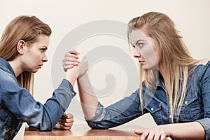 Two women having arm wrestling fight