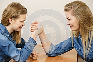 Two women having arm wrestling fight