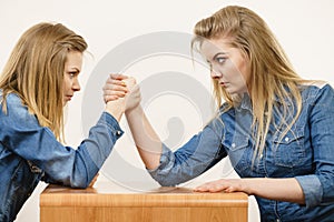 Two women having arm wrestling fight