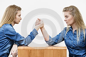 Two women having arm wrestling fight