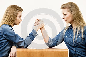 Two women having arm wrestling fight