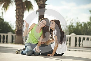 Two women having fun under palm trees