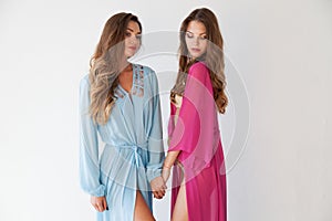 Two women hold hands fashion portrait nice