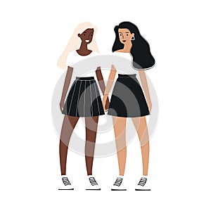Two women holding hands, one African ethnicity Caucasian, wearing skirts sneakers. Friends photo