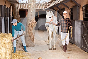 Two women horse breeders working in ranch