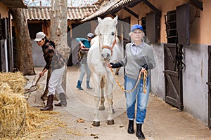 Two women horsebreeders working in ranch
