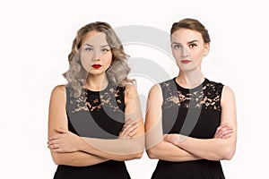 Two women in identical dresses are angry at each other