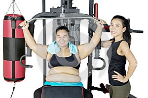 Two women instructing a workout with a smile