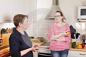 Two women kitchen bad mood