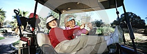 Two Women Laughing In Golf Cart