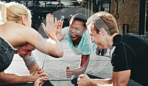 Two women laughing and high fiving during a planking class