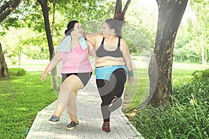 Two women laughing in the park