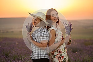 Two women with lavender bunches on the sunset