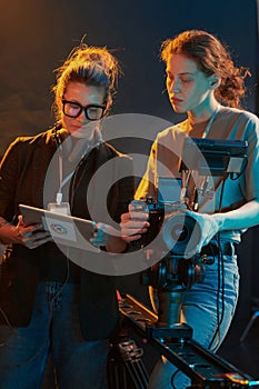 Two Women Looking at Digital Tablet in Studio