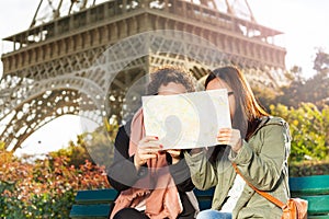 Two women looking at map during excursion in Paris