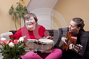 Two women make a music therapy