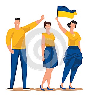 Two women and a man holding a Ukrainian flag, standing together in solidarity. Patriotic group showing support for