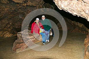 Two women, members of the tourist group, pose against the backdrop of the cave. Red Cave