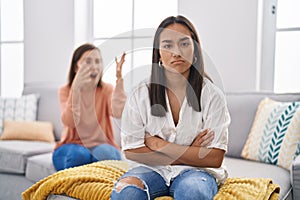 Two women mother and daughter arguing at home