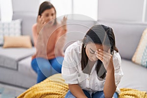 Two women mother and daughter arguing at home