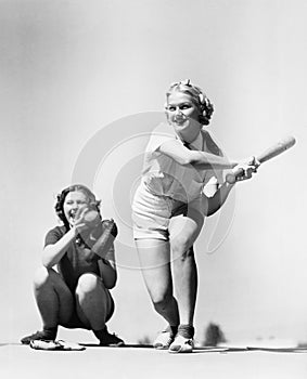 Two women playing baseball