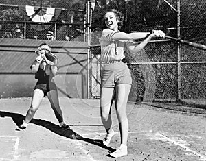 Two women playing baseball