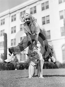 Two women playing leap frog together photo