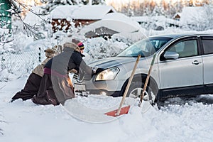 Two women pushing a car