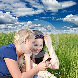 Two women reading sms