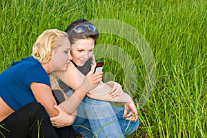 Two women reading sms