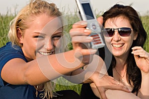 Two women reading sms