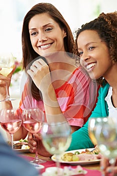 Two Women Relaxing At Dinner Party