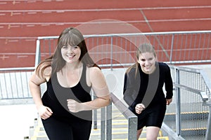 Two women running up stairs outside