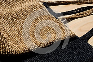 Two women's bags made of raffia black and beige