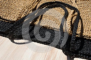 Two women\'s bags made of raffia black and beige