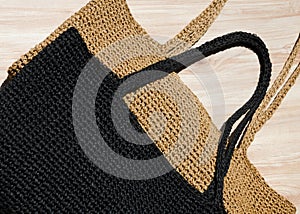 Two women\'s bags made of raffia black and beige