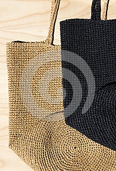 Two women\'s EKO bags made of raffia black and beige