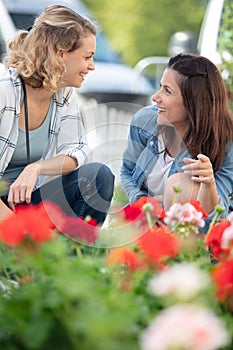 two women same-sex family embrace under blossoming park