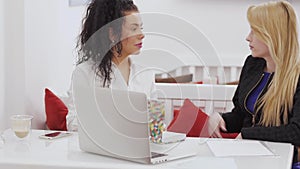 Two women saying goodbye to each other in cafe