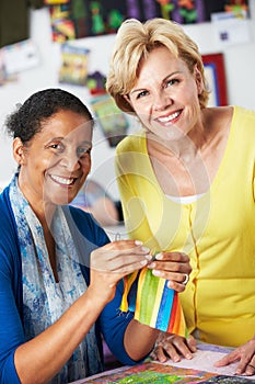 Two Women Sewing Quilt Together