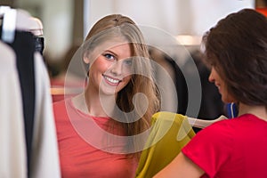 Two Women shopping choosing dresses